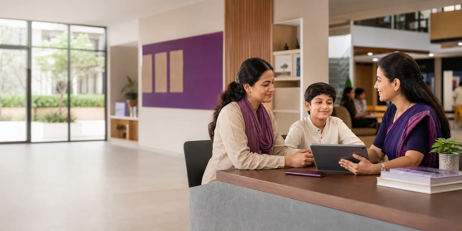 A school administrator meeting with a parent and student
